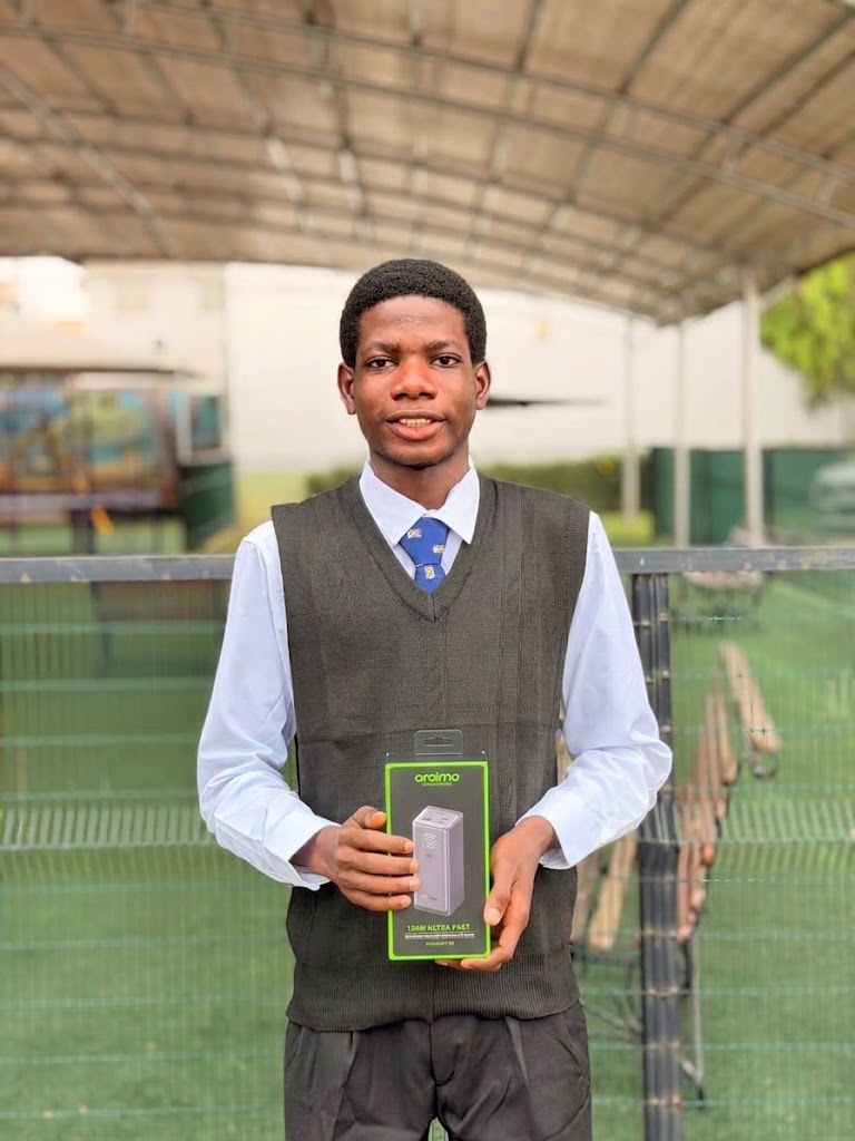 Ubuntu Bridge Initiative participant holding a power bank support award